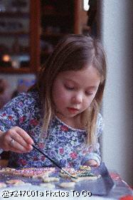 Girl decorating Christmas cookies Girl decorating Christmas cookies